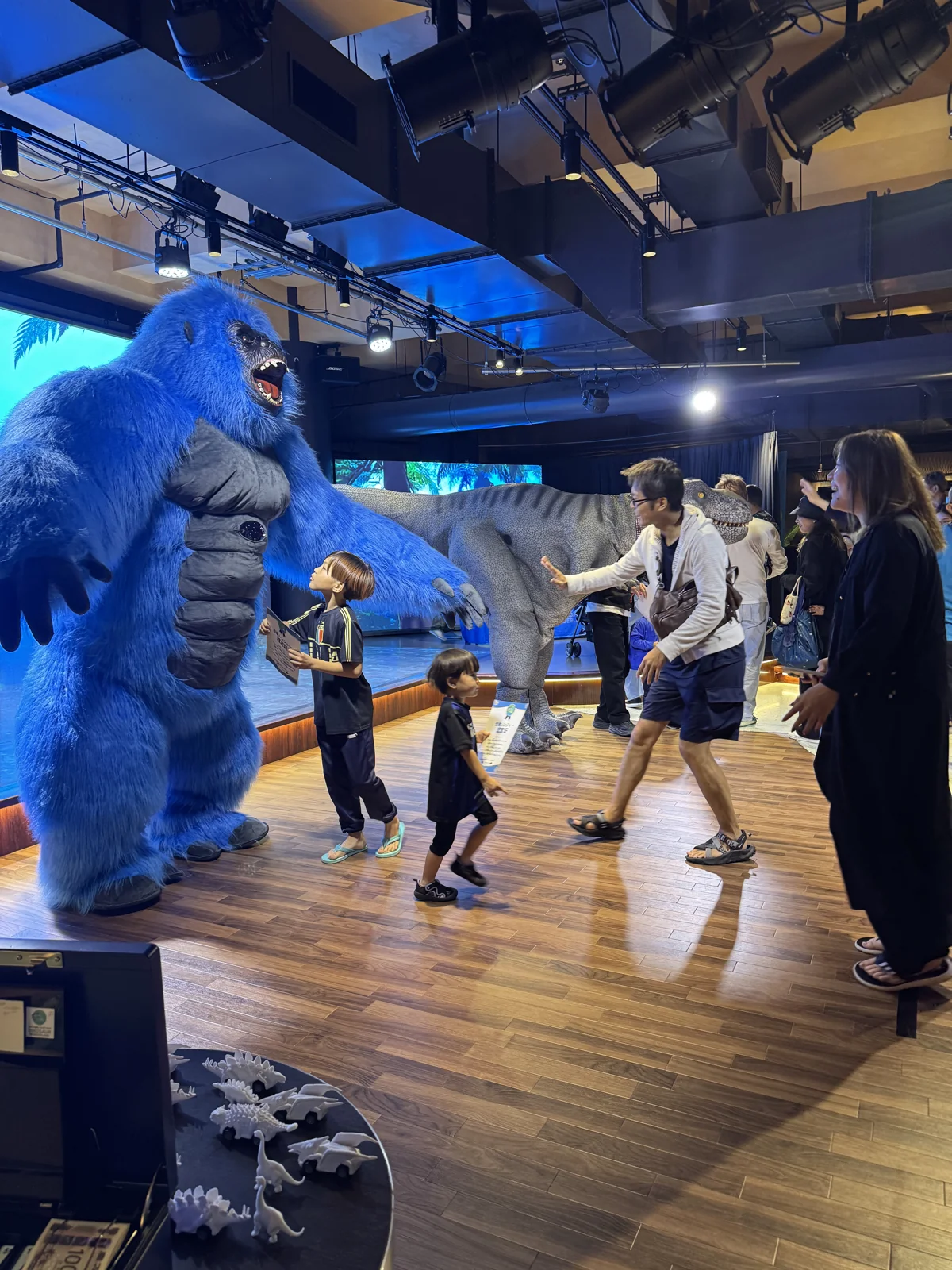 よみうりランドの屋内会場で、子どもたちが巨大コングと恐竜にふれあっている様子